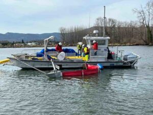 A boat in the water with Boom