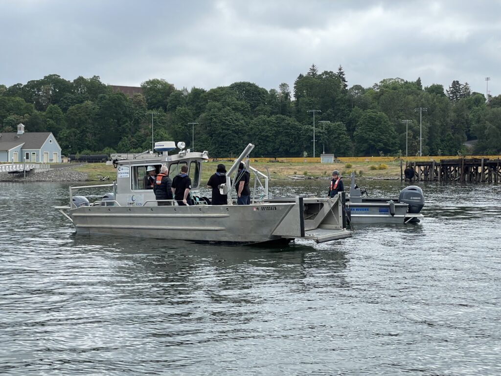 2 boat in the water with people on them talking